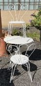 A wrought iron and painted wood circular garden table, diameter 74cm, height 76cm and a pair of