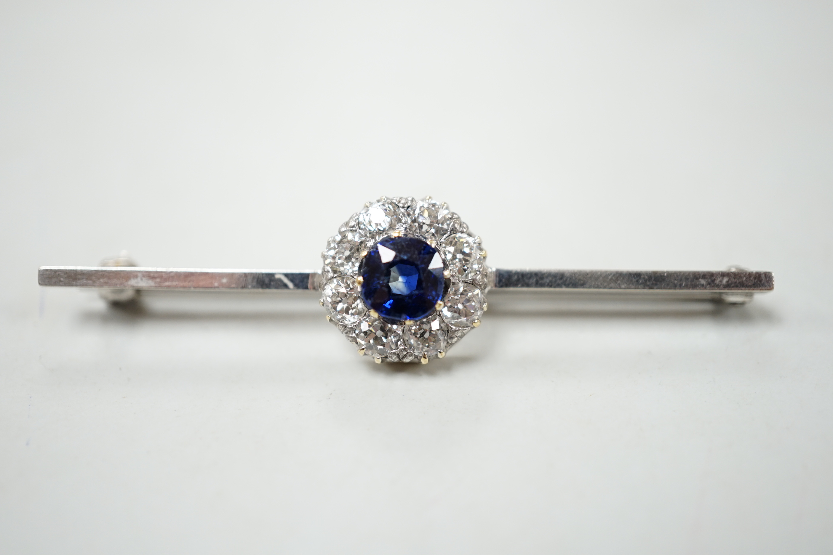 A mid 20th century white metal, sapphire and diamond cluster set bar brooch, 55mm, gross weight 4. - Image 2 of 4