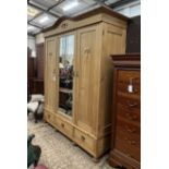 A late 19th century East European 'knock flat' pine three door mirrored wardrobe, width 172cm, depth