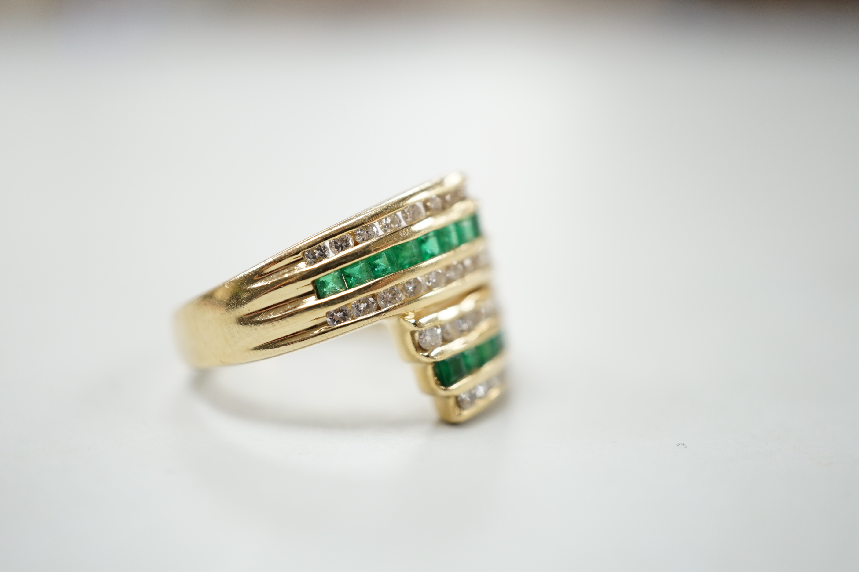 A modern 14k yellow metal, emerald and diamond chip set triple row crossover ring, size O, gross - Image 3 of 4