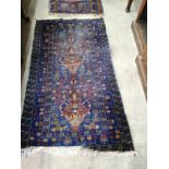 A Caucasian blue ground carpet, approx. 290 x 162cm together with a near pair of smaller North