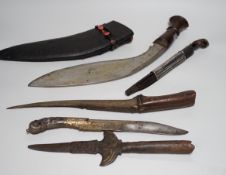 Two Sinhalese daggers and a kukri, a silver inlaid Kirichchiya dagger, together with another in a