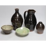 Two green glazed dishes by Jack Kenny, two dark glazed vases, a similar jug and a small bowl,