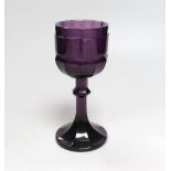 A Bohemian amethyst goblet, seemingly cut from a single piece of glass in a facetted form with a