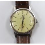 A gentleman's 1960's? stainless steel Omega Seamaster manual wind wrist watch, on associated leather