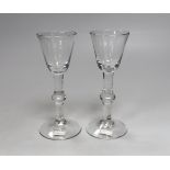 A pair of English lead crystal balustroid wine glasses, c.1740-50, toolmarked round funnel bowls