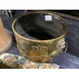 A 19th century circular Dutch embossed brass coal bin with lion mask ring handles, diameter 46cm,