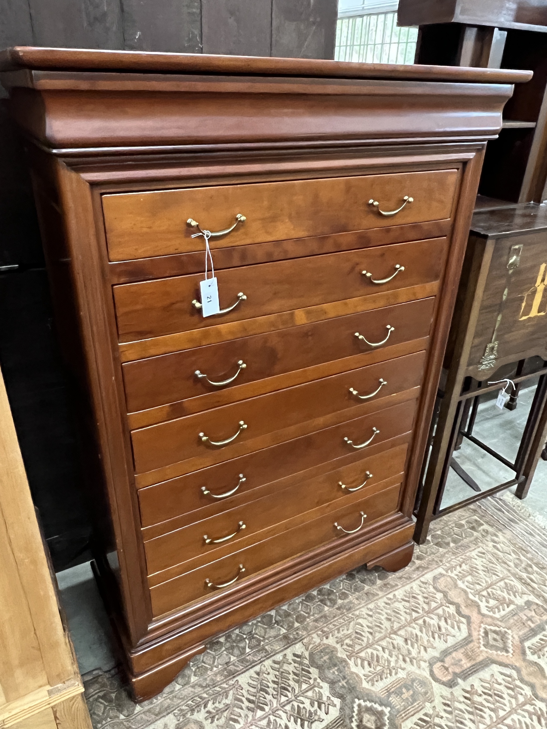 A reproduction French style cherry wood seven drawer semainier, width 99cm, depth 47cm, height