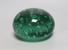 A green glass dump weight, 14cm in diameter