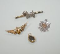 An early 20th century 9ct, citrine and seed pearl set winged heart brooch, 39mm, a silver dog bar