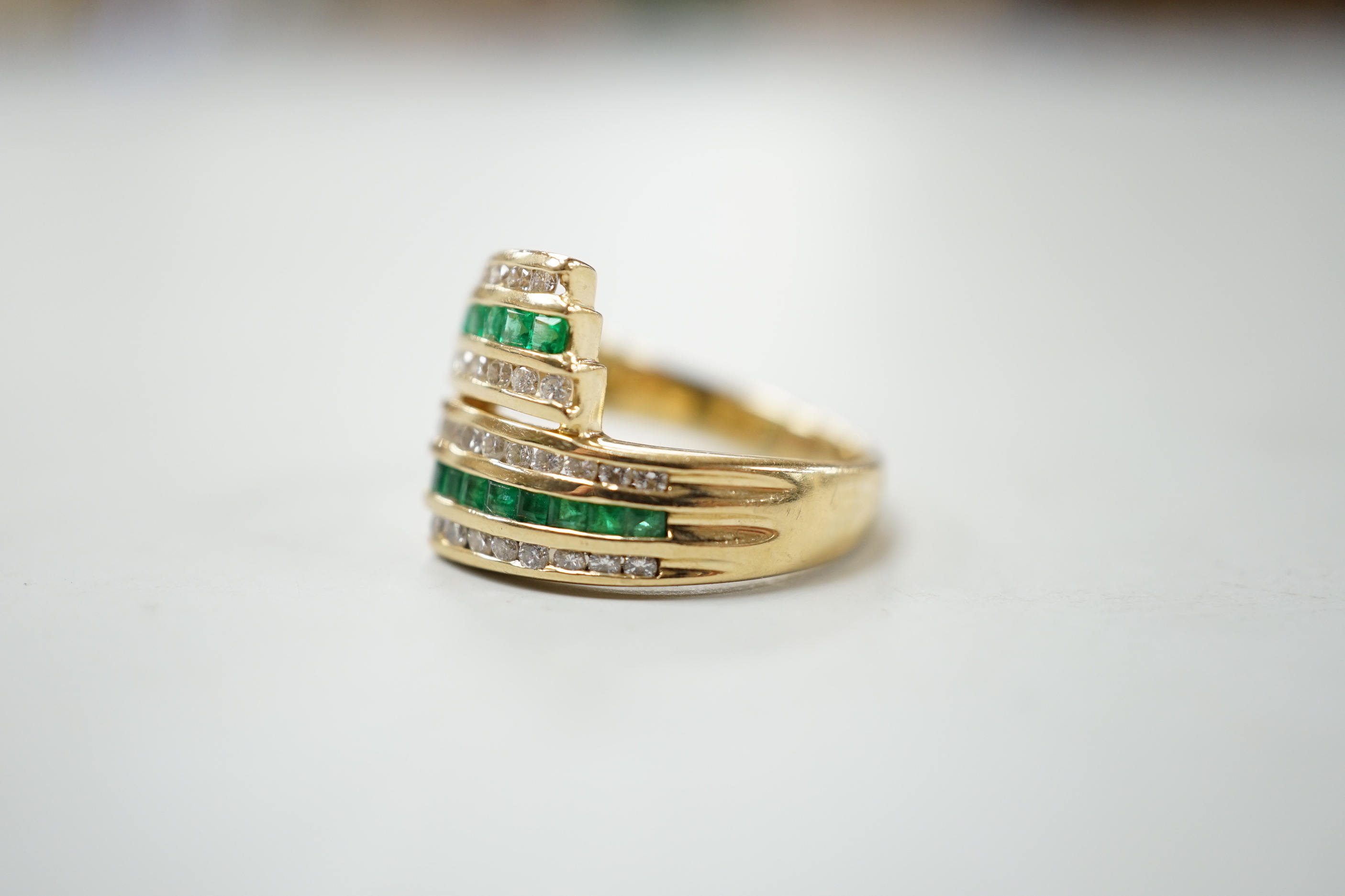 A modern 14k yellow metal, emerald and diamond chip set triple row crossover ring, size O, gross - Image 2 of 4
