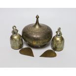 A pair of Eastern brass bells and lidded jar, largest 12cm high