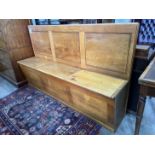 A mid century oak hall settle with triple hinged box seat, width 178cm, depth 40cm, height 106cm