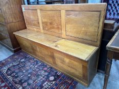 A mid century oak hall settle with triple hinged box seat, width 178cm, depth 40cm, height 106cm