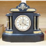 A Victorian black slate mantel clock with brass pillars, striking on a gong, height 33.5cm