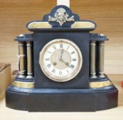 A Victorian black slate mantel clock with brass pillars, striking on a gong, height 33.5cm