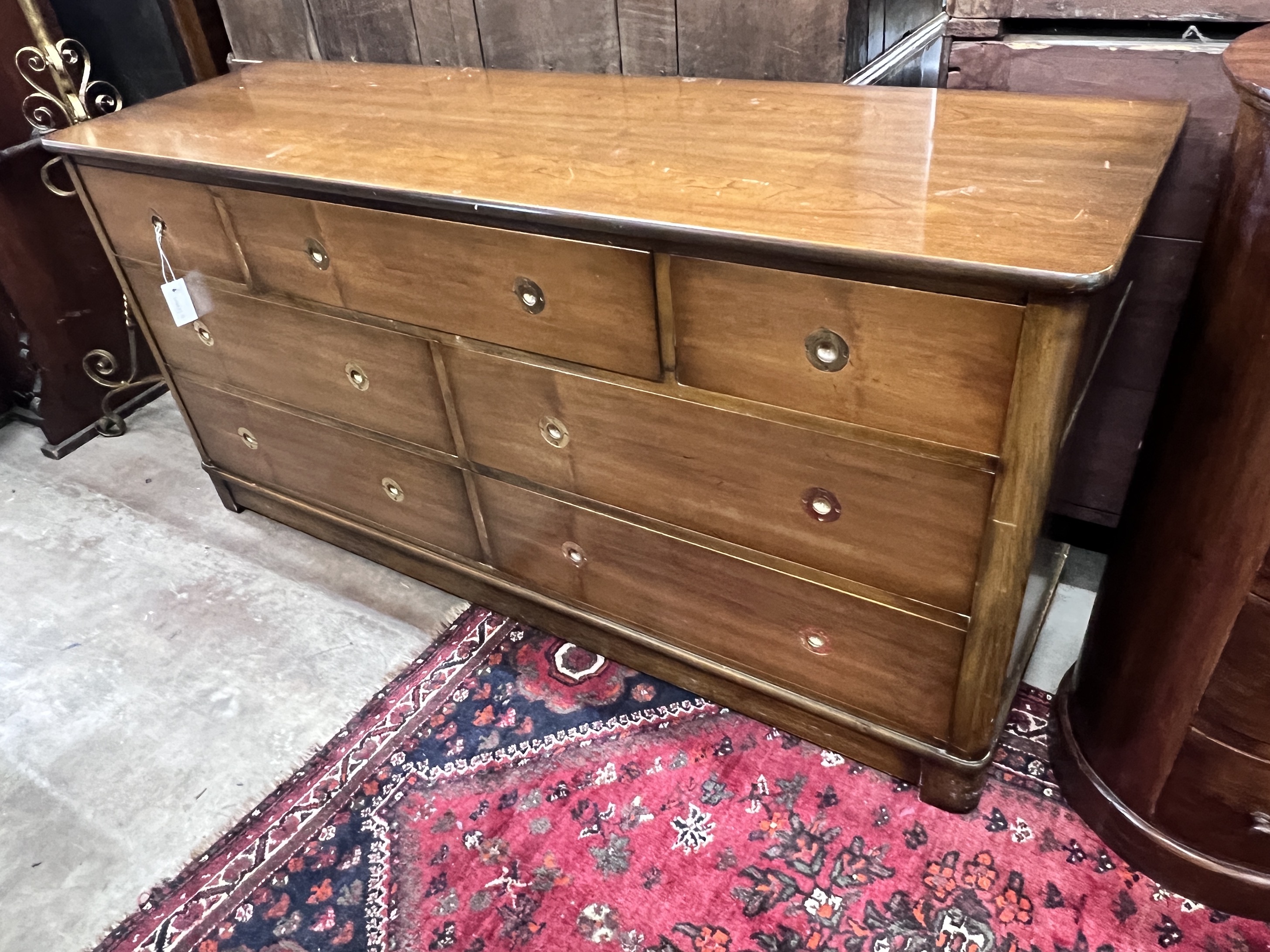 A reproduction mahogany military style dresser fitted seven small drawers, with recessed brass