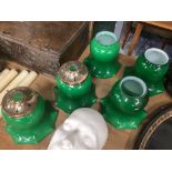 A set of five green glass shades, 18cm high