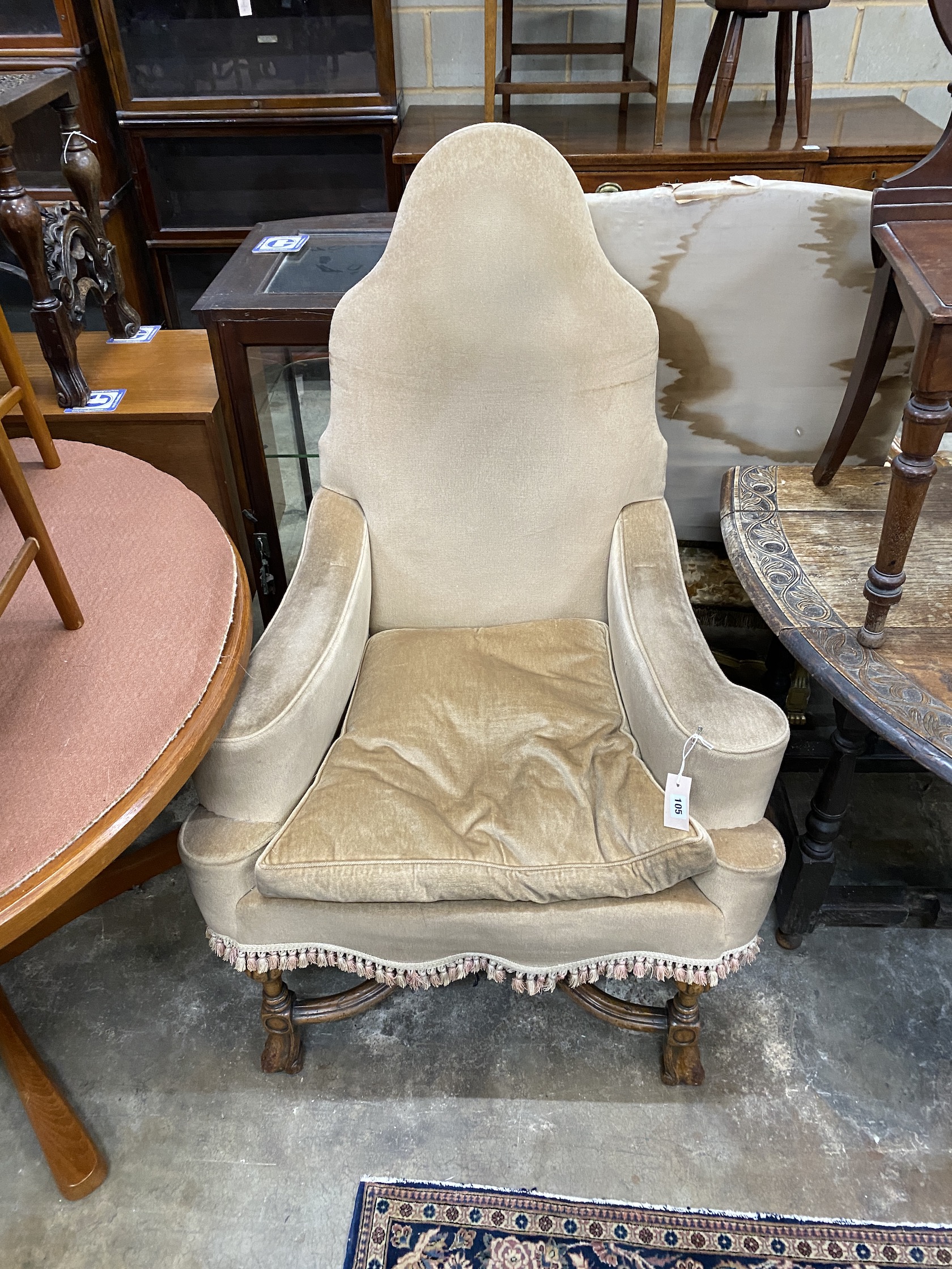 An 18th century style upholstered wing armchair, width 81cm, depth 76cm, height 126cm