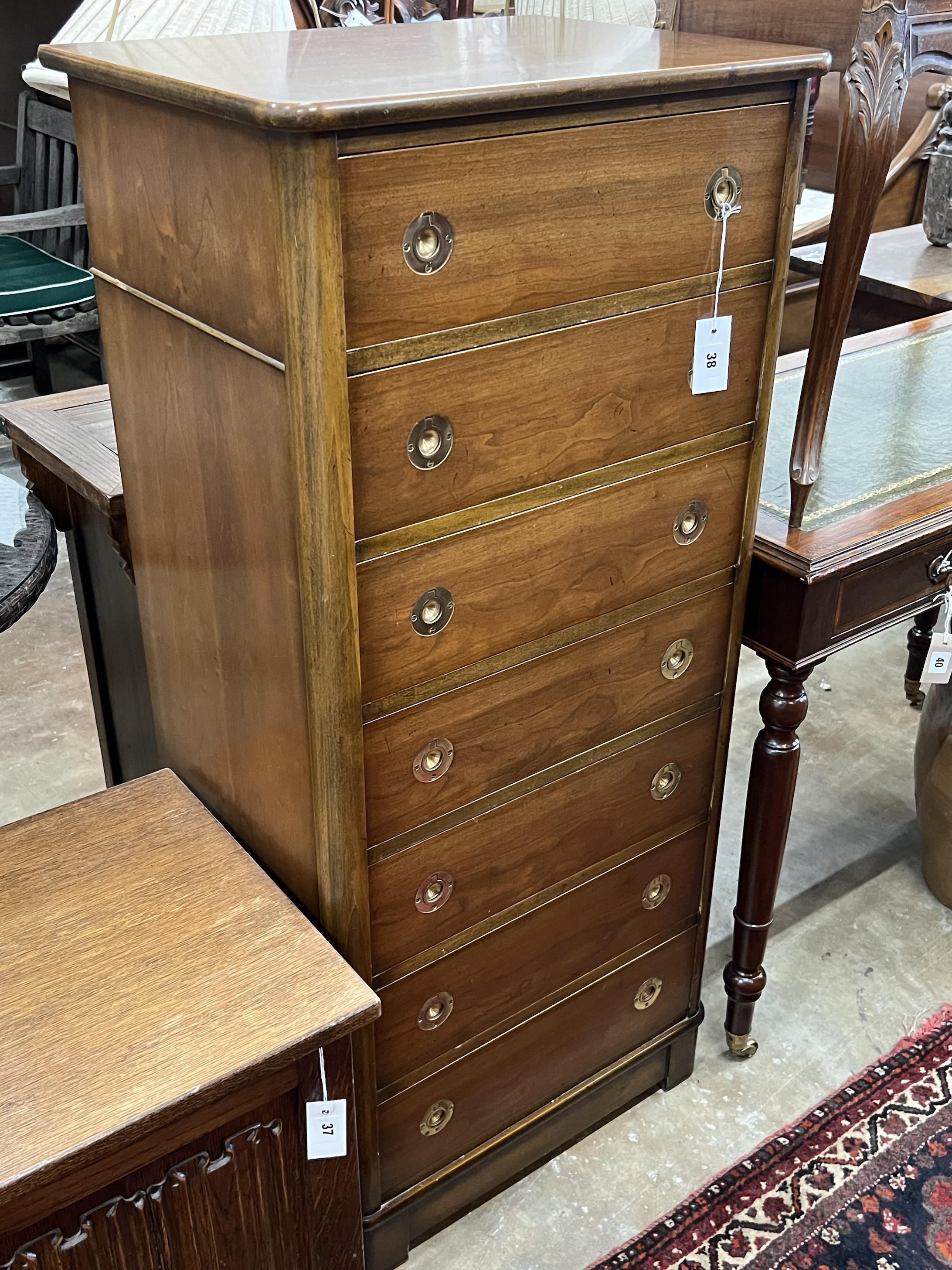 A military style seven drawer tall chest, with recessed brass handles width 57cm, depth 43cm, height