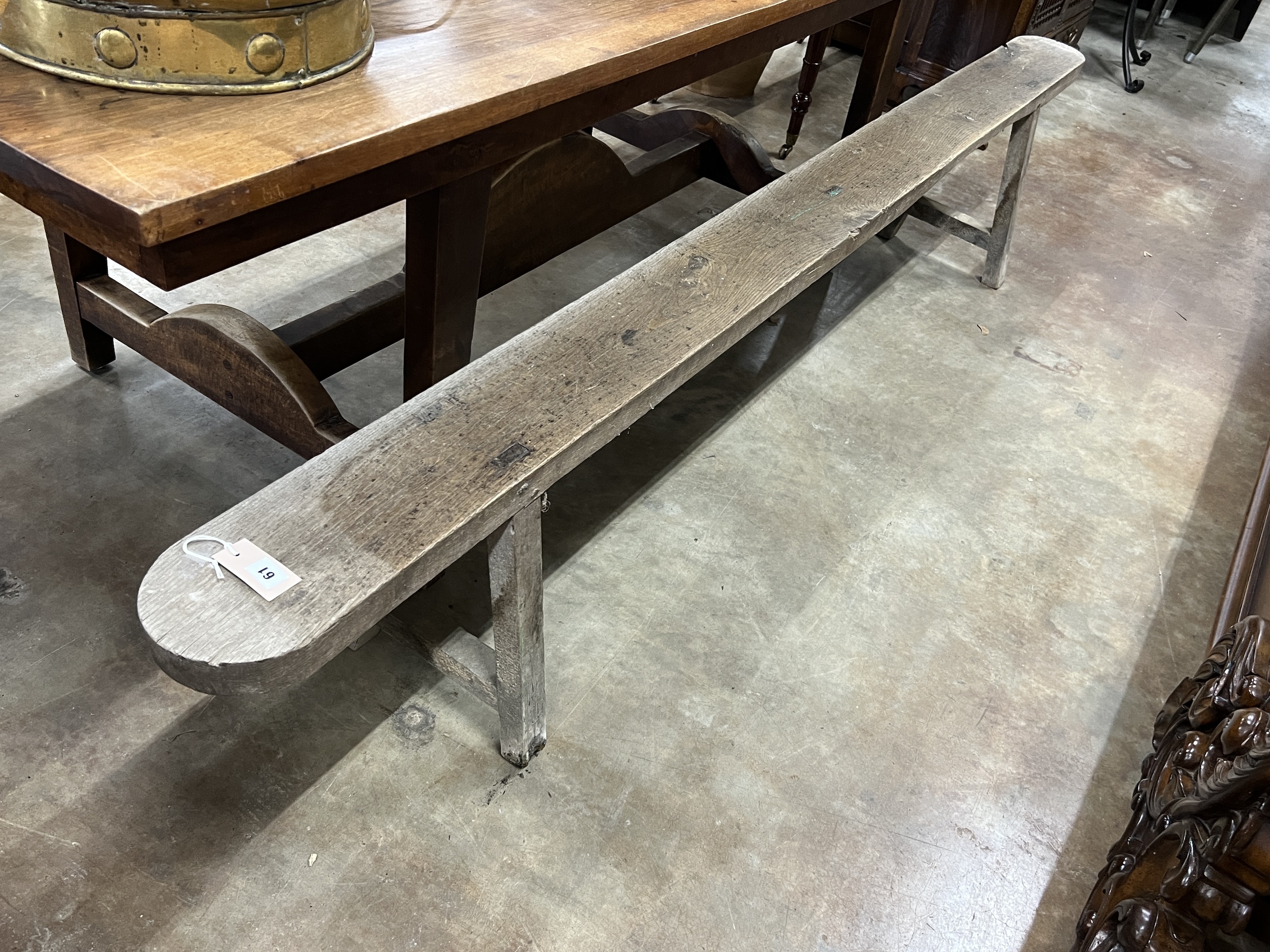 A 19th century French oak bench seat, length 251cm, depth 17cm, height 45cm