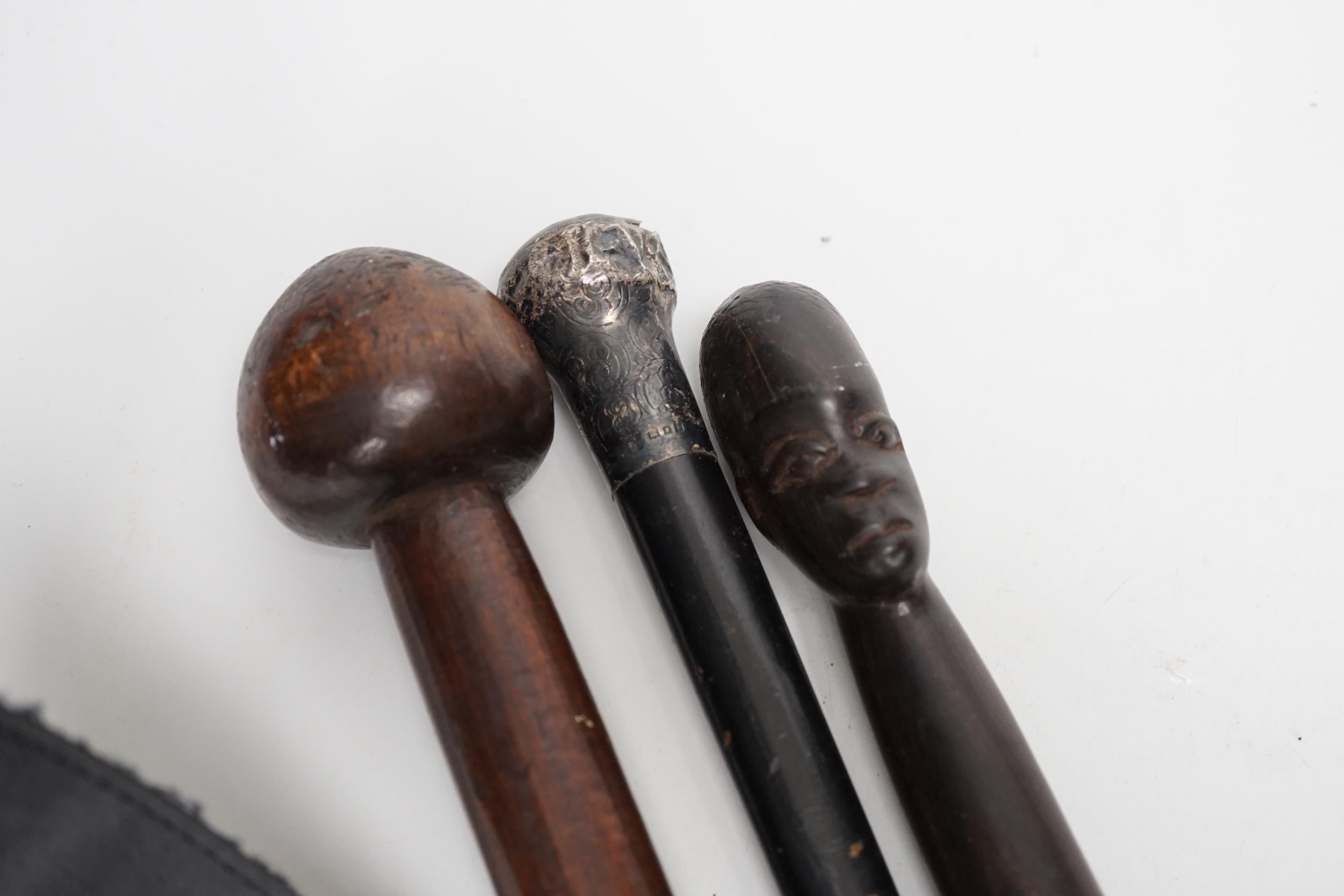 A silver topped walking cane and two African carved wood canes - Image 3 of 6