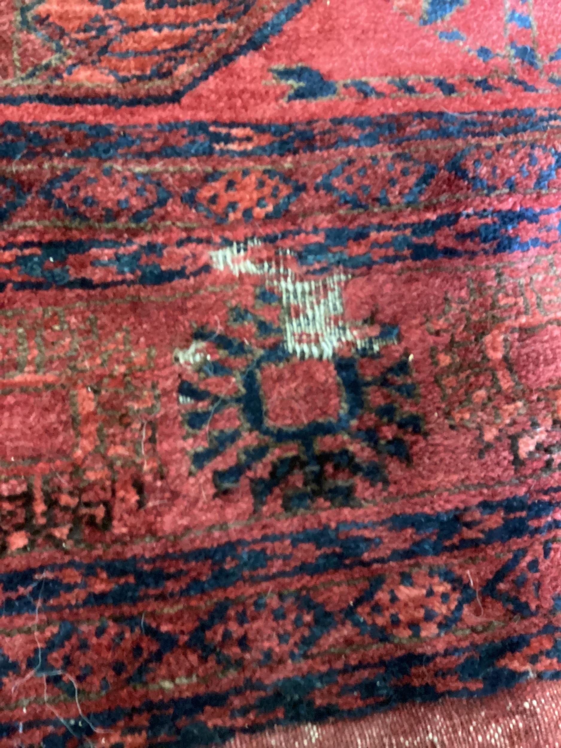 A Bokhara red ground carpet, worn and holed, 286 x 214cm - Bild 2 aus 4