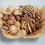 A carved wood bowl and fruit