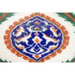 A large Turkish Iznik pottery tile, decorated with stylised flowers, 34cm x 25cm