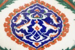 A large Turkish Iznik pottery tile, decorated with stylised flowers, 34cm x 25cm