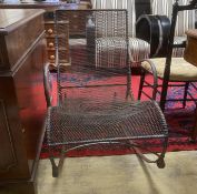 A vintage wrought iron and mesh garden rocking chair, width 53cm, depth 85cm, height 78cm