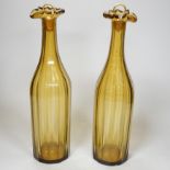 A pair of early 19th century amber panel cut glass decanters, 30cm