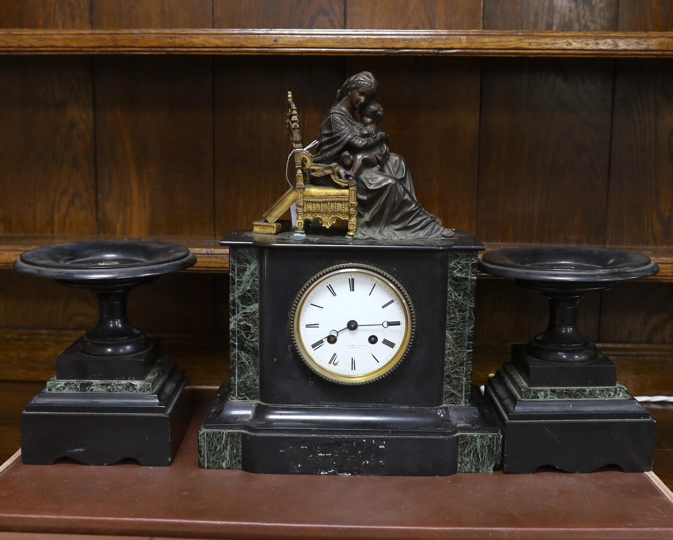 A late 19th century French black slate clock garniture with seated mother and child metal mount,