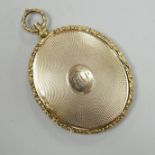 A Victorian engine turned yellow metal (tests as 9ct gold) oval pendant locket, housing a