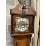 An early 19th century mahogany and banded oak eight day longcase clock marked Thomas Quested, Wye,