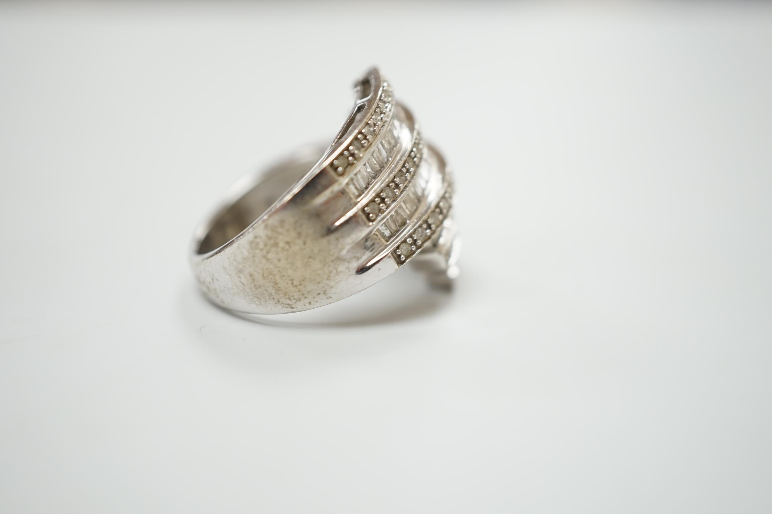 A 9ct white gold and dress ring designed with nine bands of brilliant and baguette cut stones, - Image 2 of 3