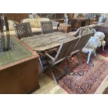 A weathered teak folding garden table, width 150cm, depth 80cm, height 70cm together with four