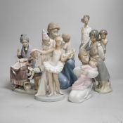 A large Lladro figure of a seated mother and child, a pierrot and ballerina, peasant woman and