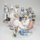Seven Lladro figures; mother baby and child, boy with train, boy with sailing boat, Eskimo