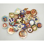 A collection of mixed badges, the majority enamelled