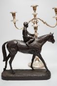 A bronzed resin racehorse and jockey group and a silver-plated three branch candelabrum -45cm high