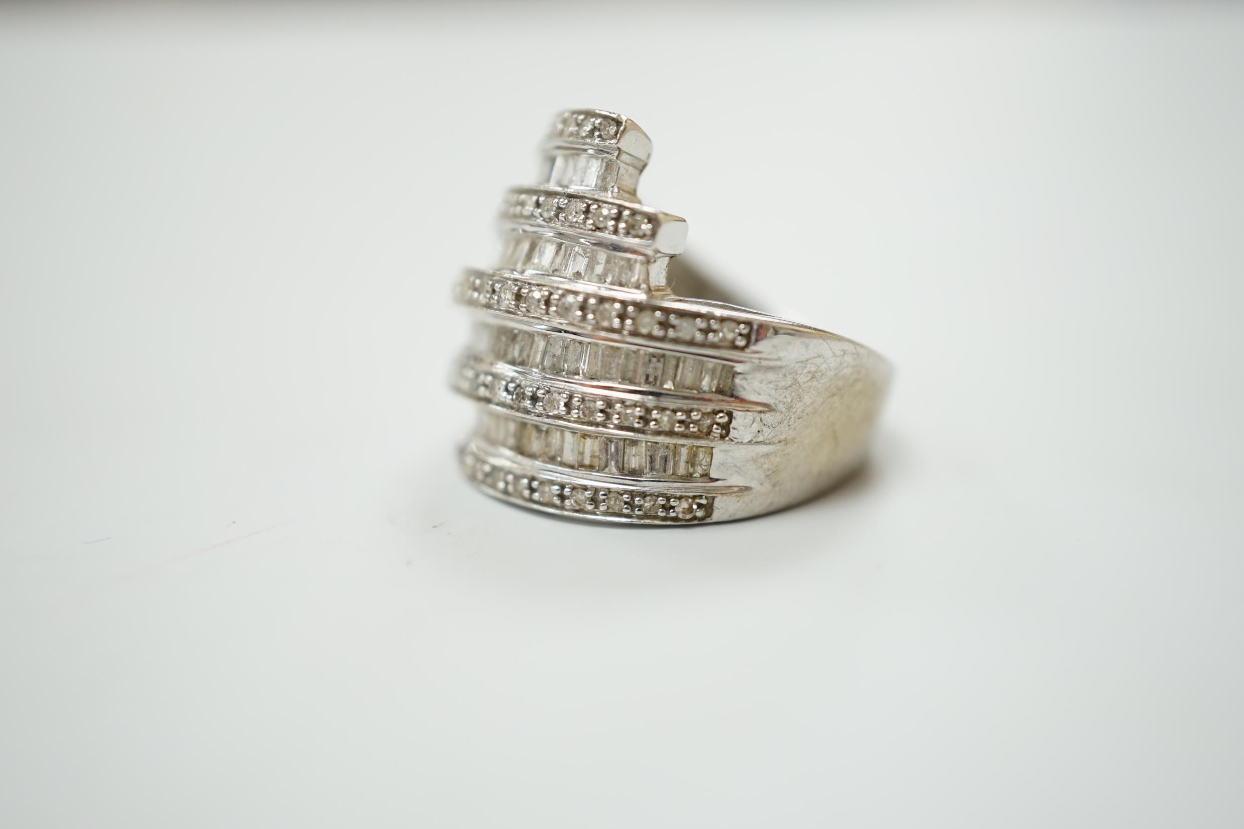 A 9ct white gold and dress ring designed with nine bands of brilliant and baguette cut stones, - Image 3 of 3