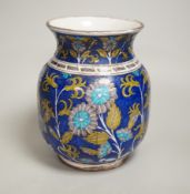 A Turkish Iznik pottery vase, decorated with flowers, 20cm high