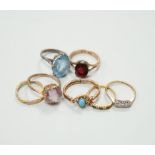 Seven assorted dress rings, comprising an 18ct gold three stone diamond ring, size M, a 9ct gold