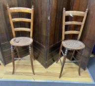 A pair of early Victorian cane seat mahogany 'correction' chairs, height 99cm