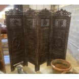 A Chinese carved hardwood four fold dressing screen, each panel width 56cm, height 199cm