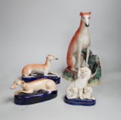 Four Staffordshire dogs including greyhounds and a spaniel, the largest 29cm high