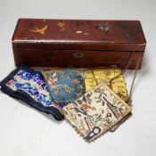 A lacquer box of Chinese embroidered purses and embroideries.