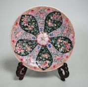 A Chinese famille rose cup stand, early Qianlong period, decorated in relief with a flowerhead, 15cm