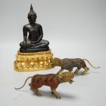 A Thai bronze Buddha raised on a gilt base and two filigree work brass and enamel tigers , the